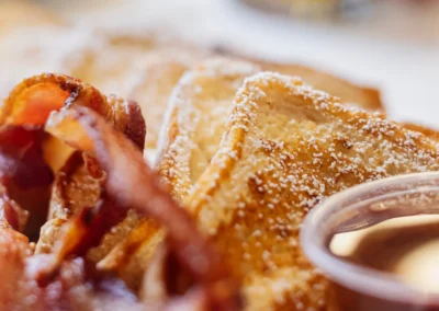 French toast and bacon with syrup and orange juice