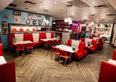 Wide view of a retro diner seating area with red booths